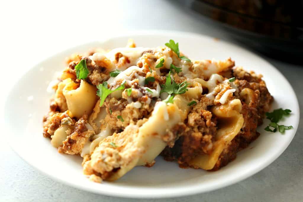 A serving of Slow Cooker Beef Lasagna on a white plate.