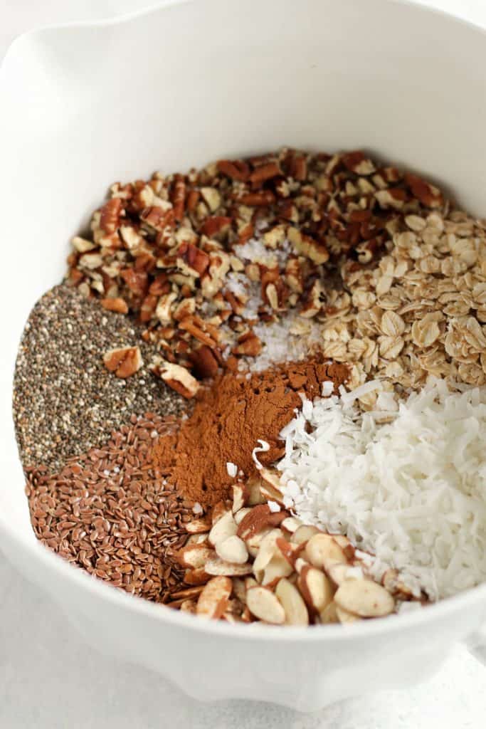 Dry ingredients for Power Packed Granola in a white mixing bowl.