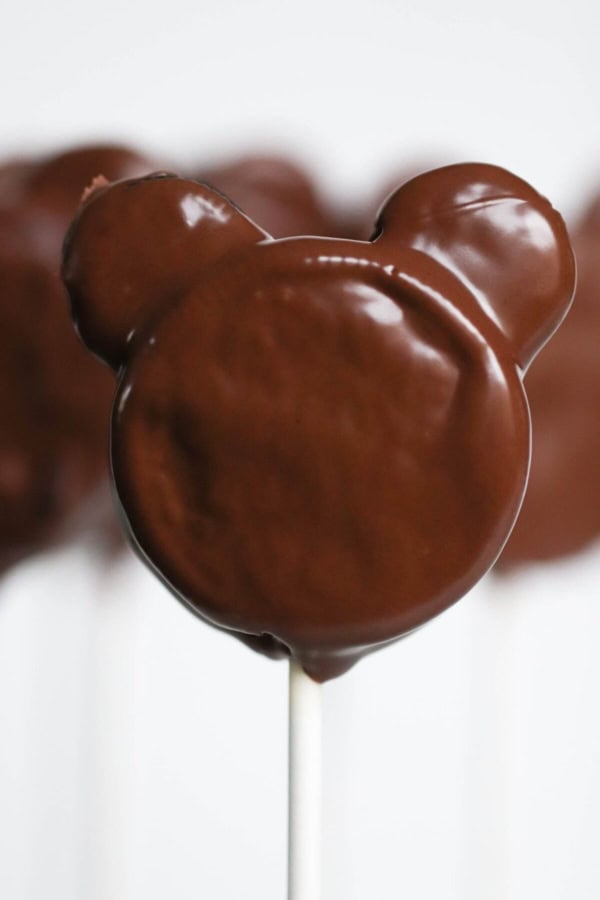 Close up of Mickey Oreo Cookie Pops covered in chocolate.