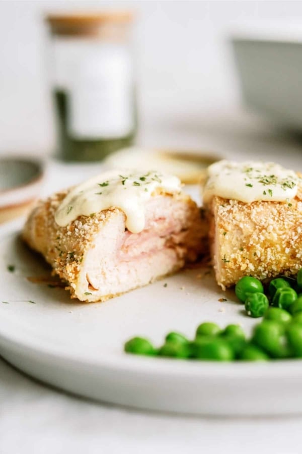 easy chicken cordon blue slice on a plate with peas
