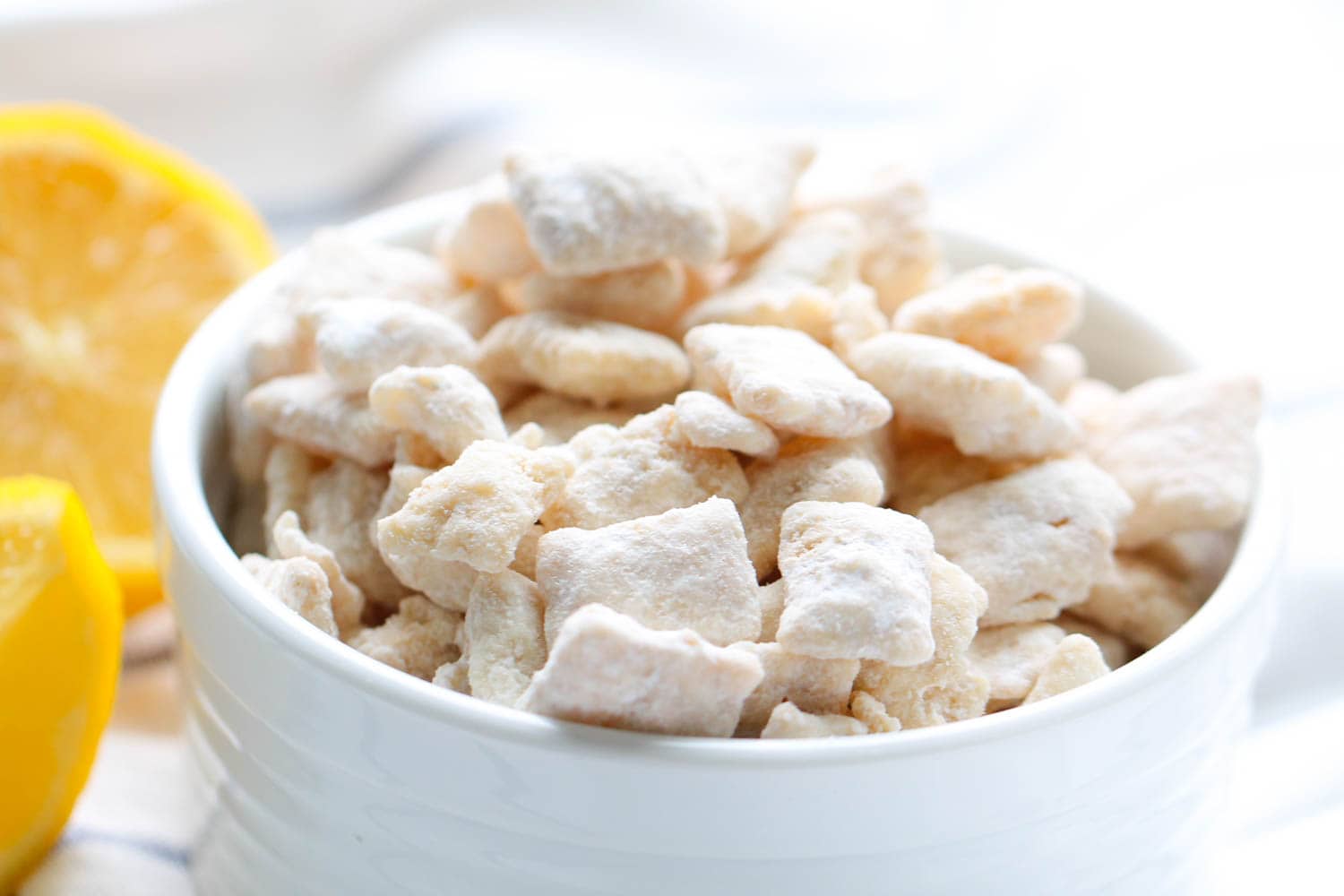 Lemon Chex Mix in a white bowl 