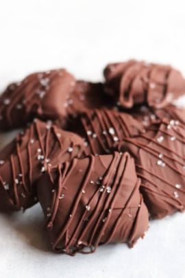 Homemade chocolate caramels with sea salt stacked in a pile.