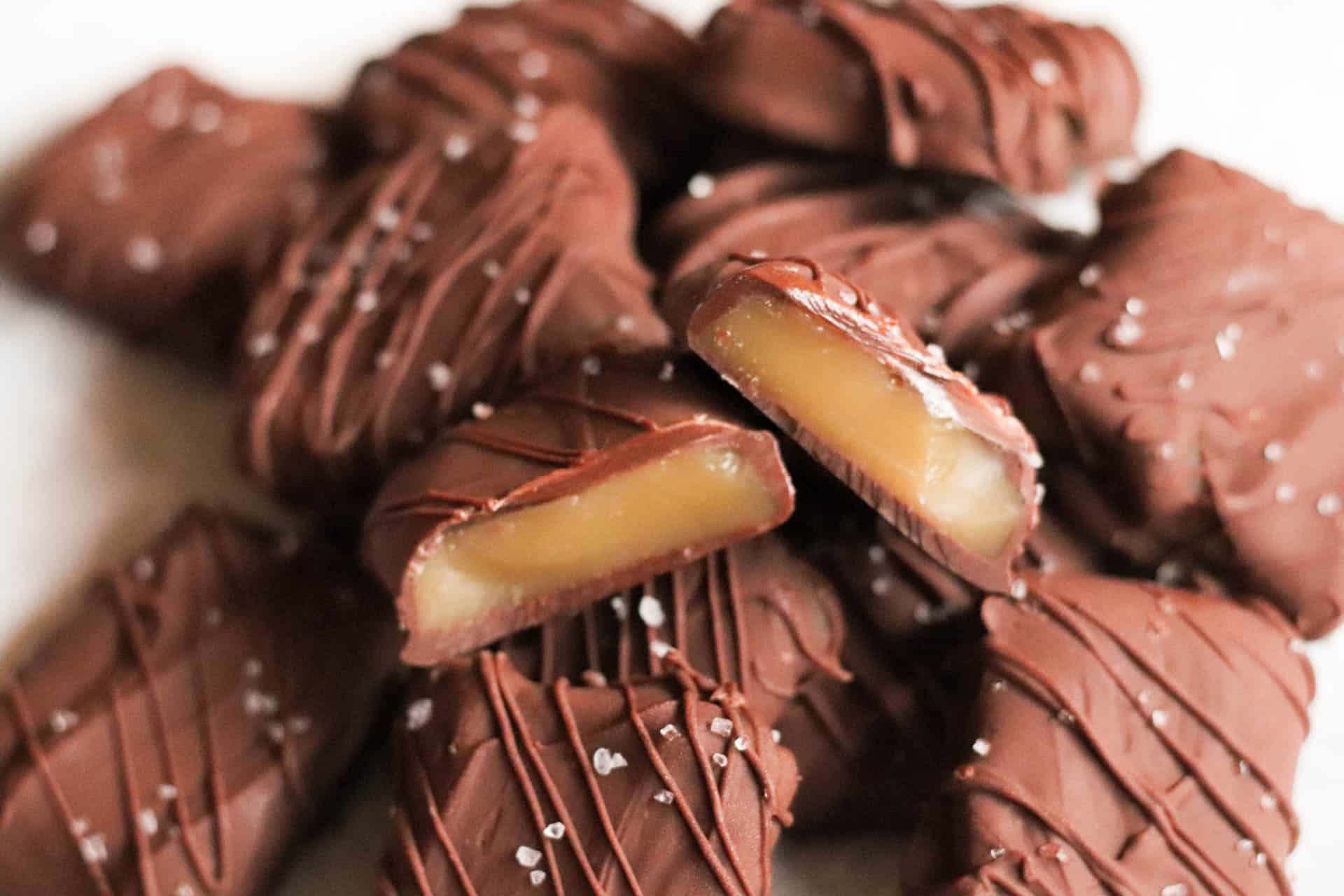 milk chocolate caramels in a pile with salt on top