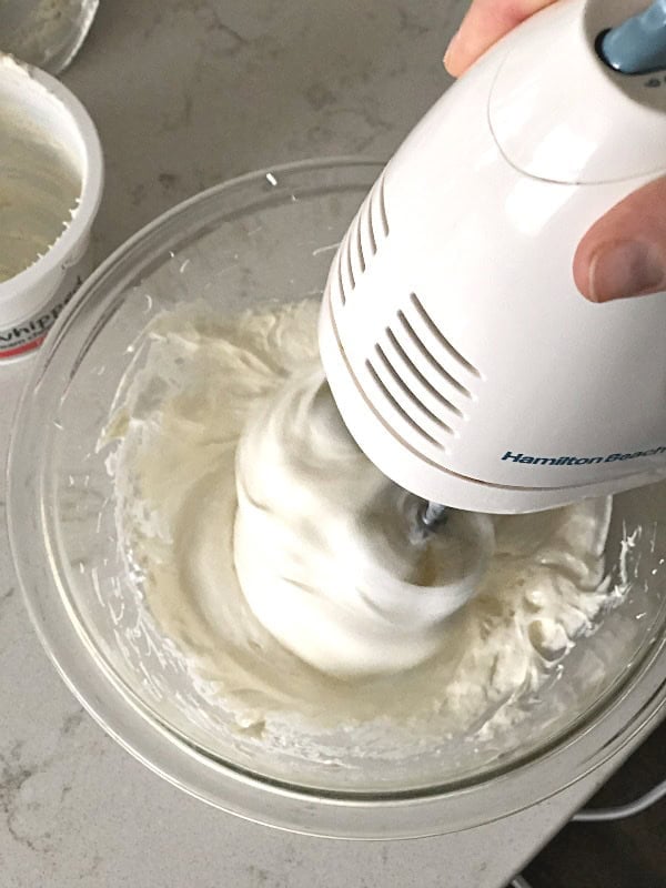 Hand mixer mixing Marshmallow Creme and Whipped cream cheese