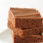 texas sheet cake brownies stacked on a plate