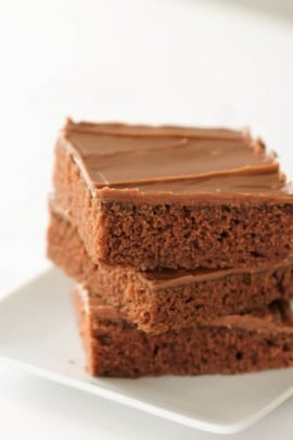texas sheet cake brownies stacked on a plate