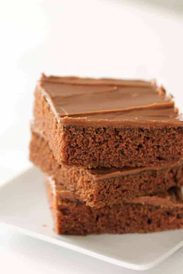 3 Texas Sheet Cake Brownies stacked on a plate