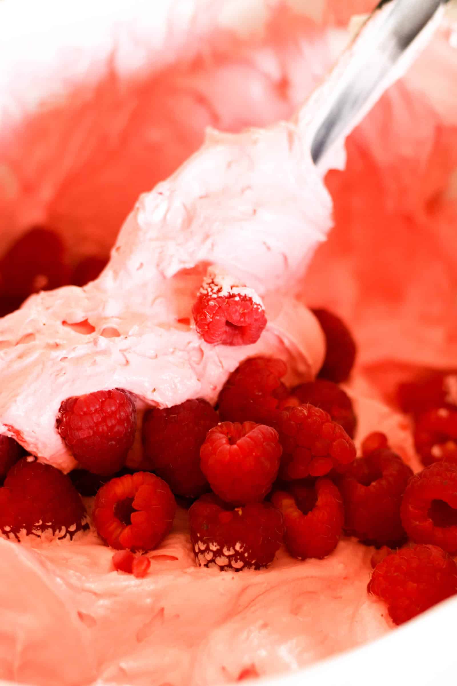 Folding in Whip cream and Raspberries into Jello Mixture