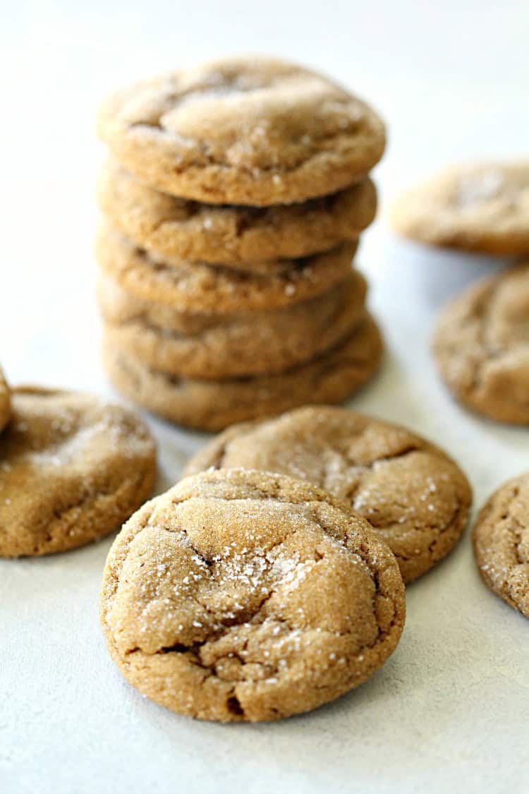 Stacked ginger cookies, with a few ginger cookies around the stack.