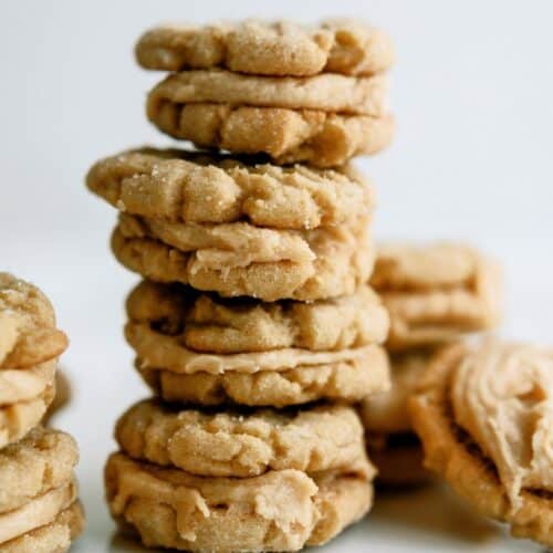 Homemade Nutter Butter Cookies stacked with a few cookies surrounding the stack.