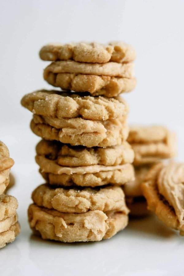 Homemade Nutter Butter Cookies stacked with a few cookies surrounding the stack.