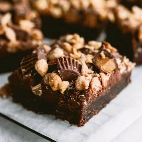 Reese’s Brownies cut into squares on a serving plate.