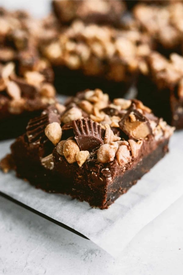 Reese’s Brownies cut into squares on a serving plate.