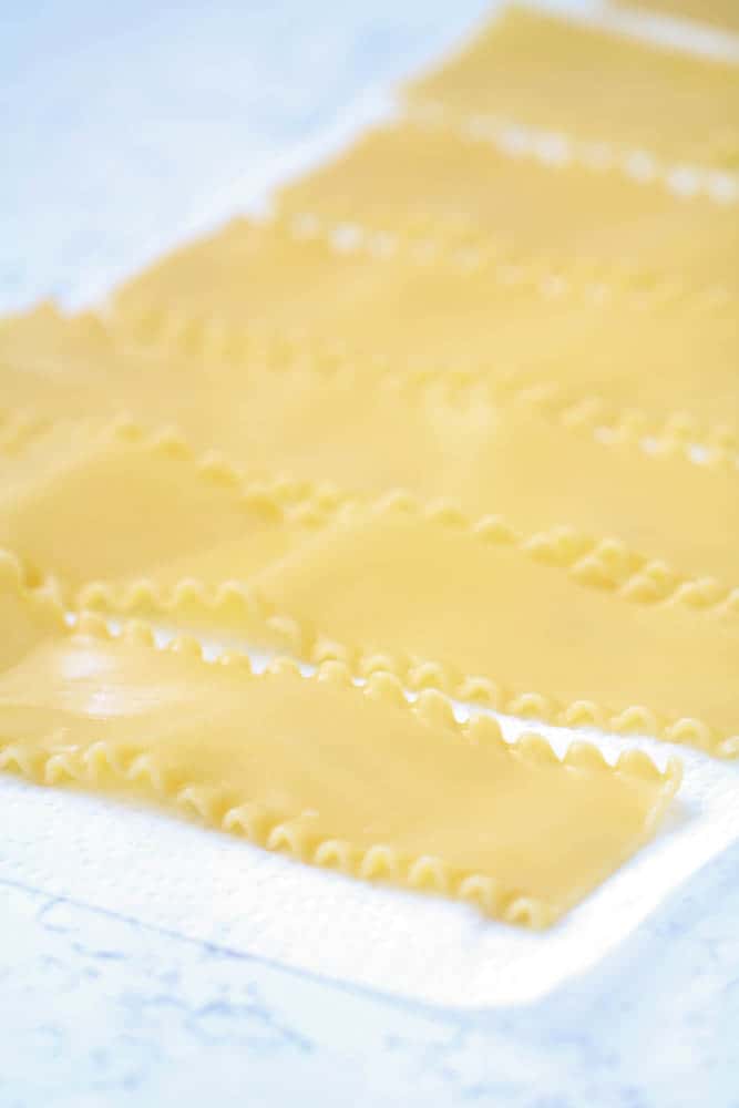 Cooked lasagna noodles laid out on counter