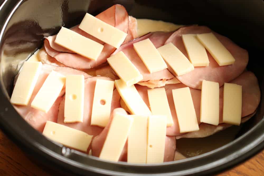 frozen chicken breasts layered with ham and swiss cheese in slow cooker