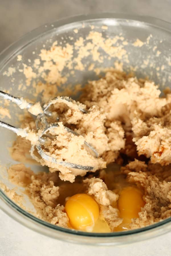 Wet cookie dough with eggs combined with a hand mixer