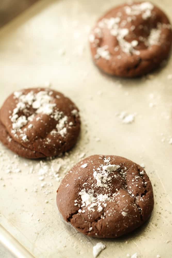 Easy rolo cookies recipe fresh out of the oven with powdered sugar on top.