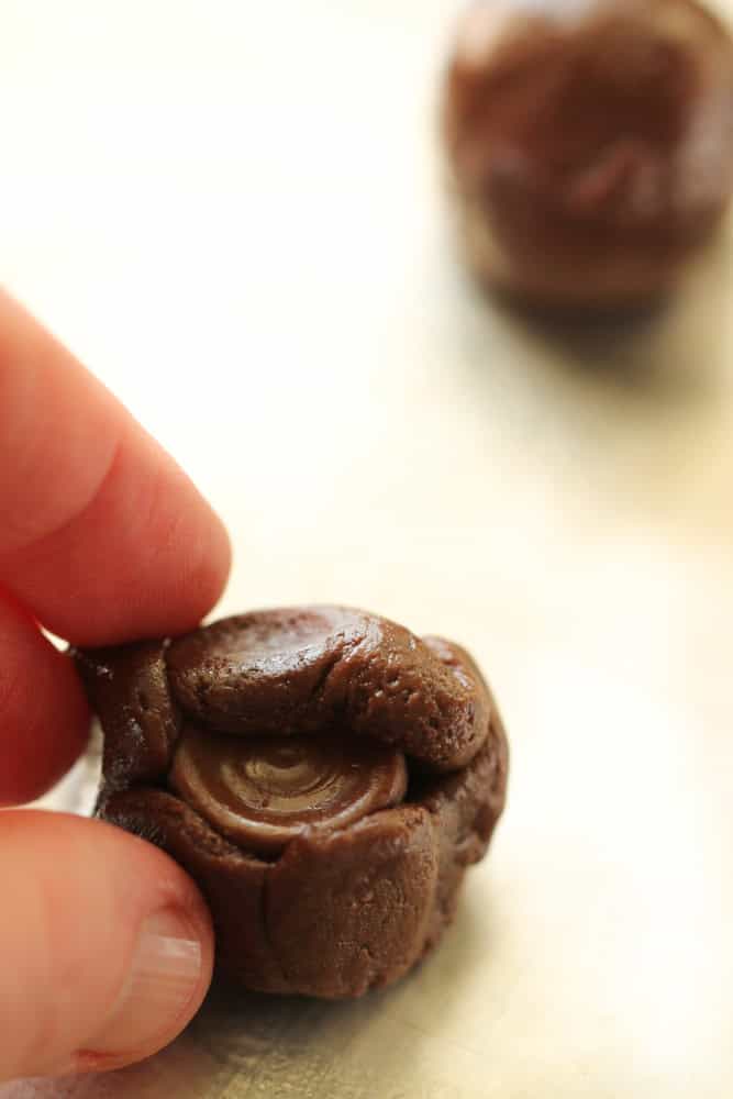Wrapping cake mix dough around a rolo candy.