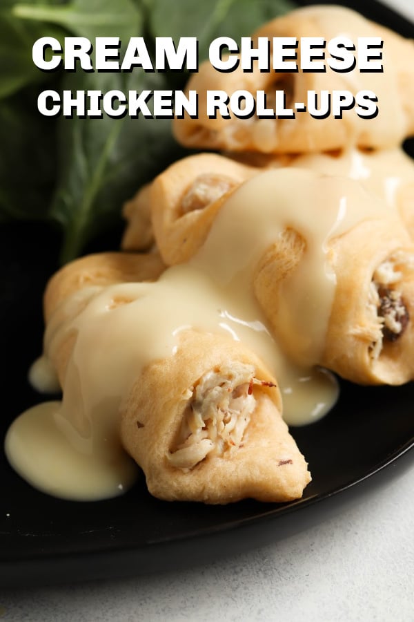 Chicken and Cream Cheese Roll-Ups topped with gravy on a black plate
