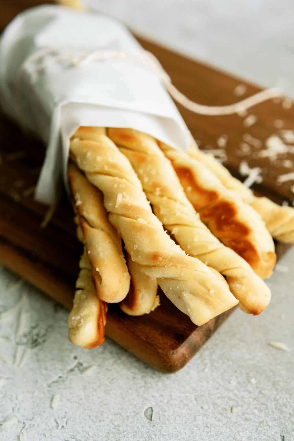 Homemade Pizza Factory Breadsticks wrapped and placed on a cutting board