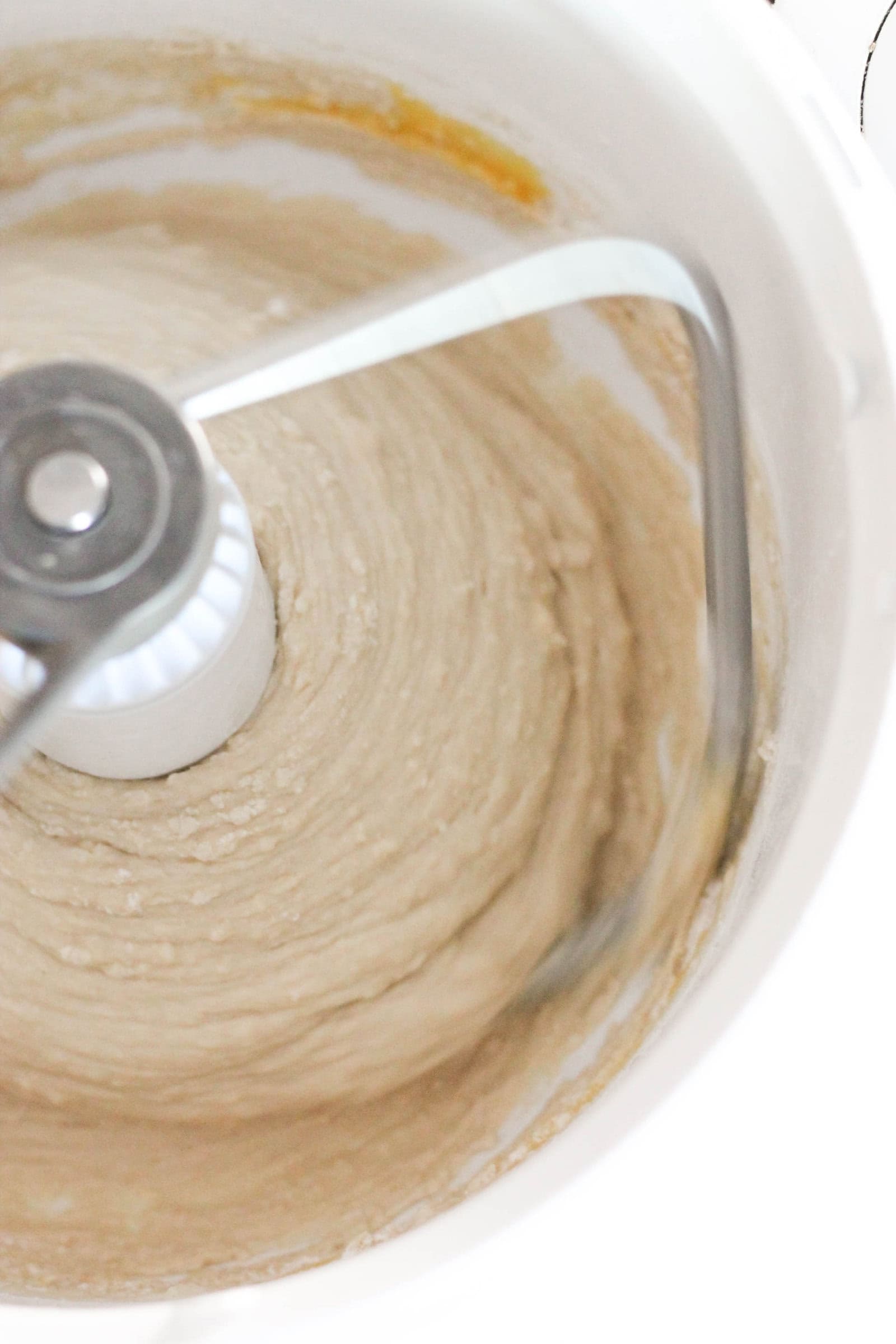 bread dough mixing in a mixer with a dough hook