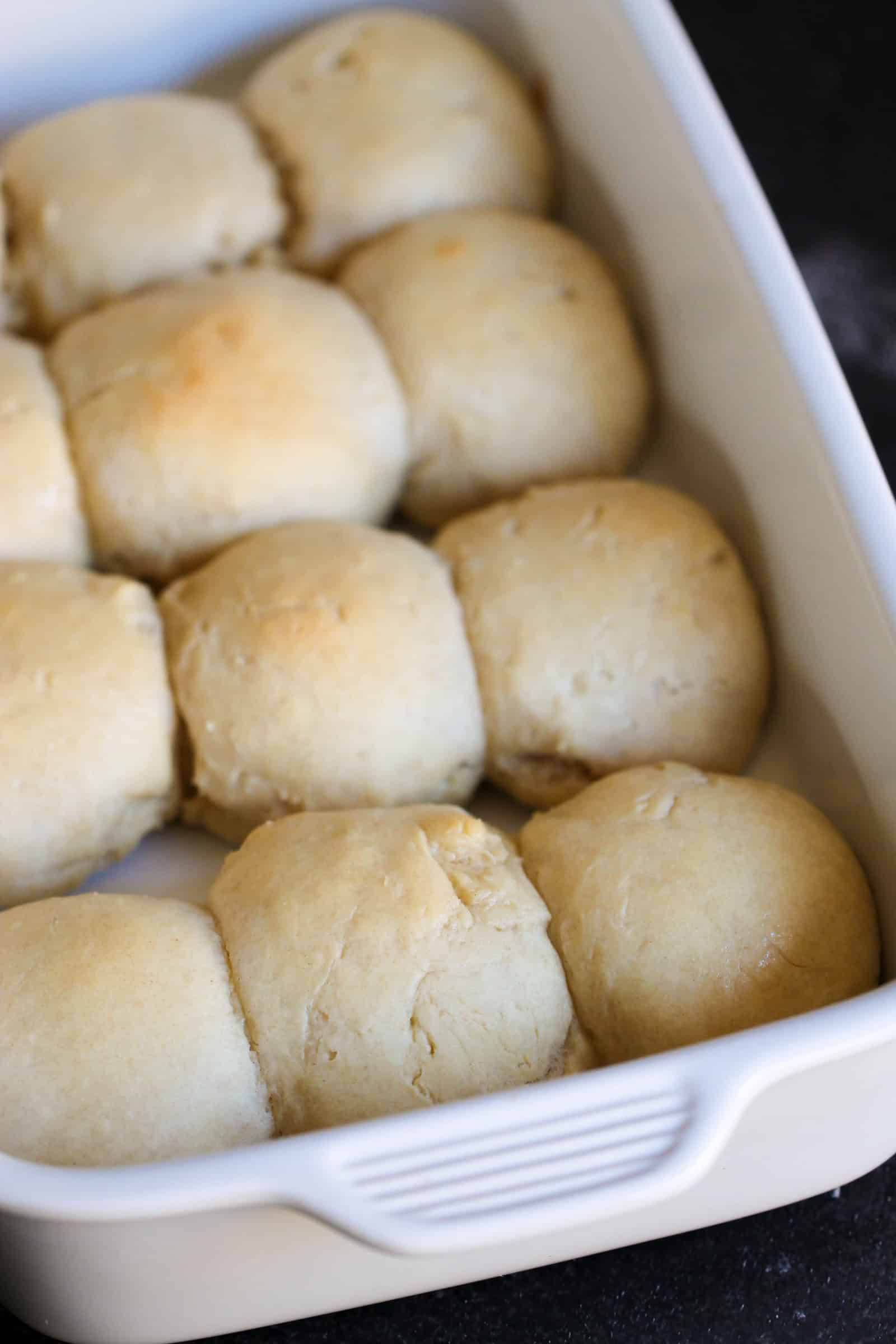 bread rolls dough rising in pan ready to cook