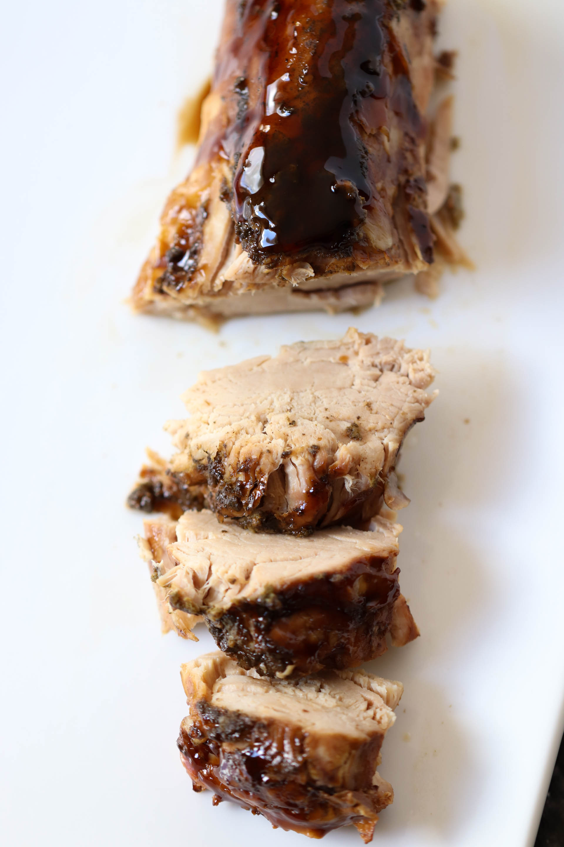 Slow Cooker Brown Sugar and Balsamic Glazed Pork Loin sliced on a plate