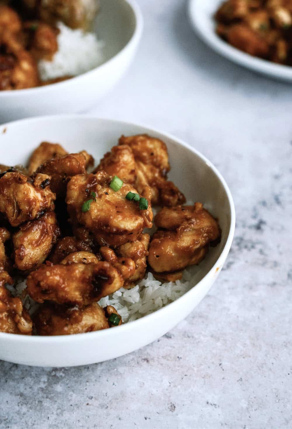 Cashew chicken served over rice in a bowl