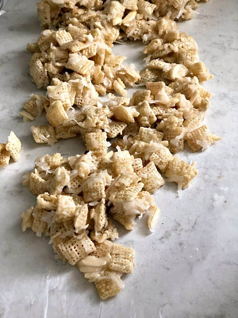 Gooey Almond and Coconut Chex Mix on wax paper.