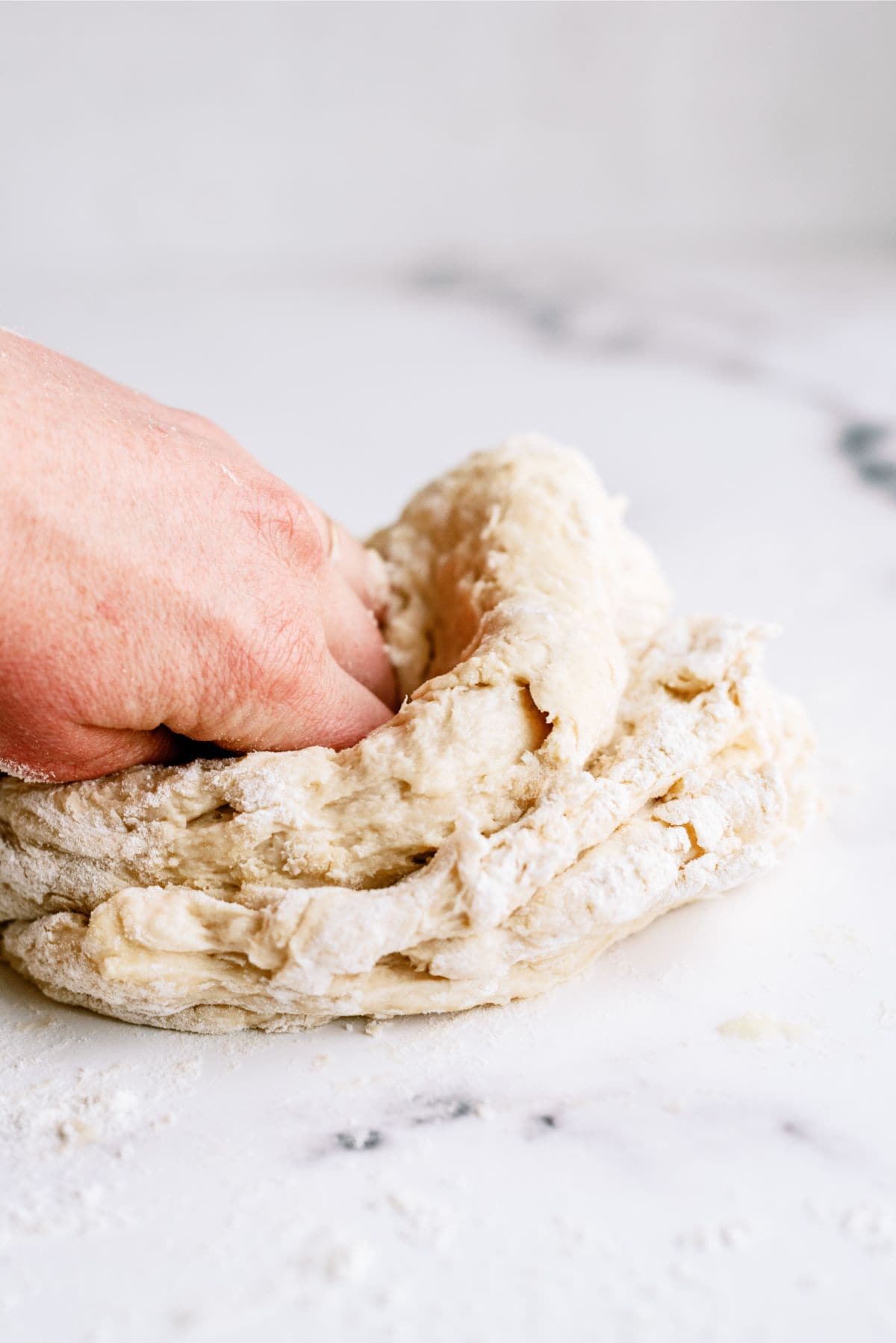 Kneading bread dough on a lightly floured surface.