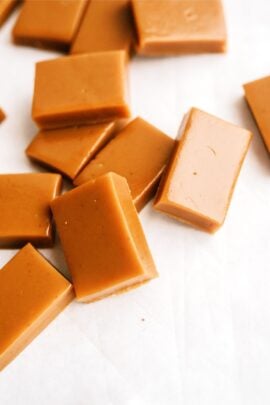 Homemade caramel candies arranged on a white surface.