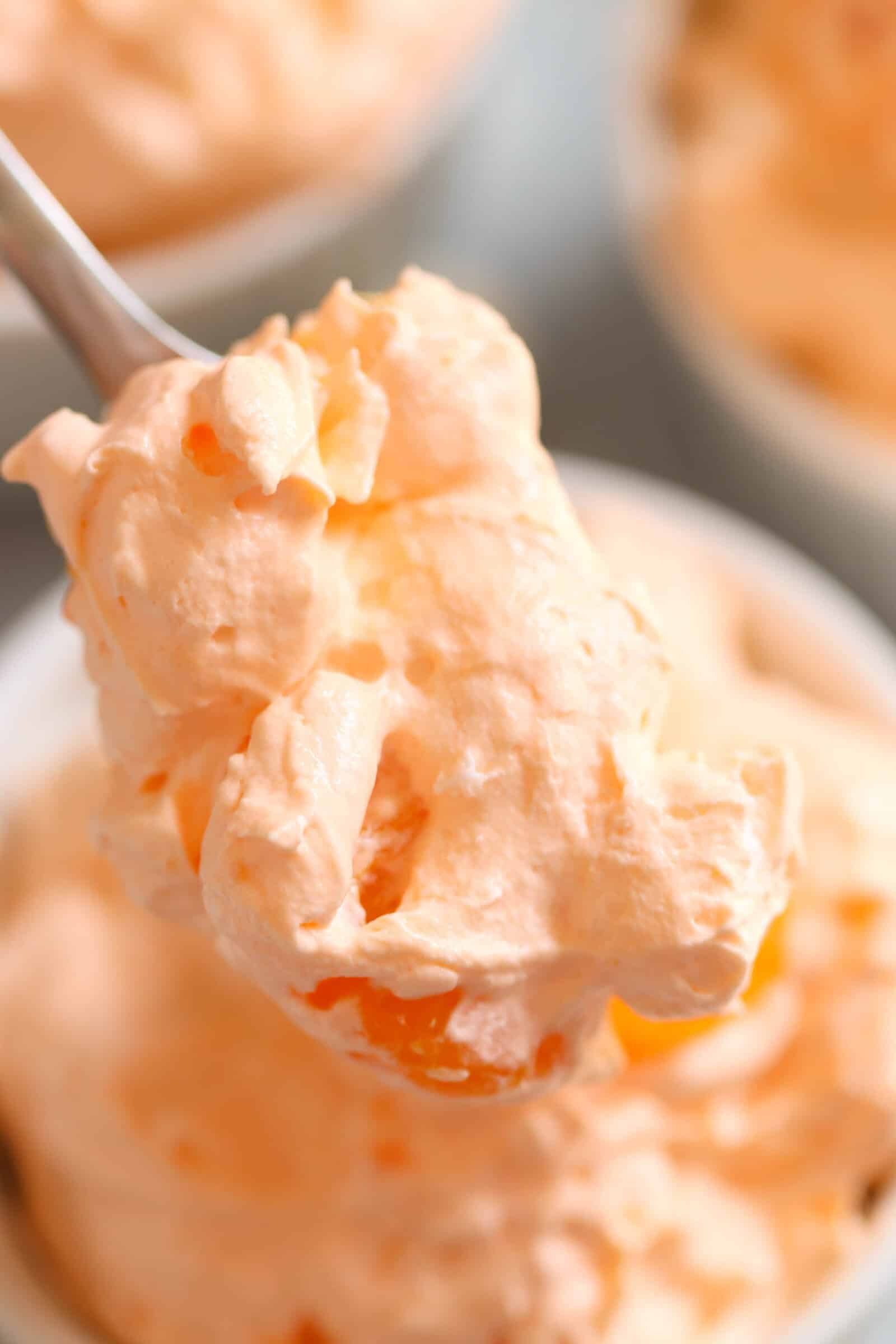 large scoop of orange jello fluff salad