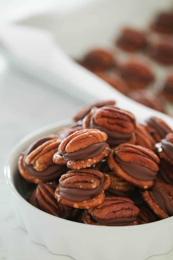 rolo turtle pretzel bites in a white bowl