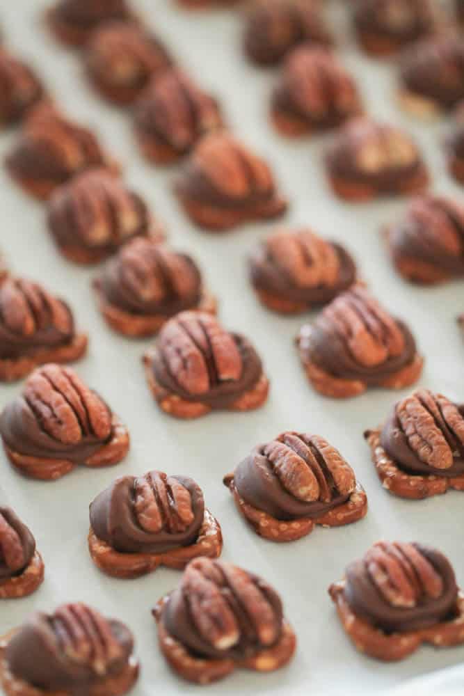 Rolo Pretzel Turtle Bites on a baking sheet lined with parchment paper.