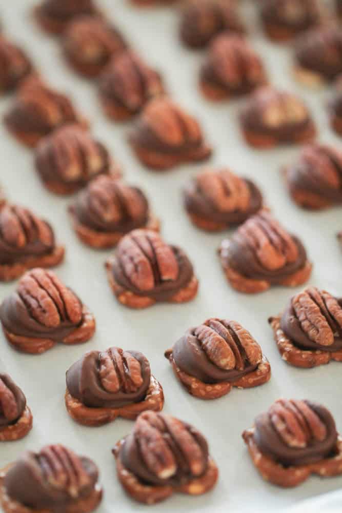 pecan on a rolo on a pretzel on a baking sheet