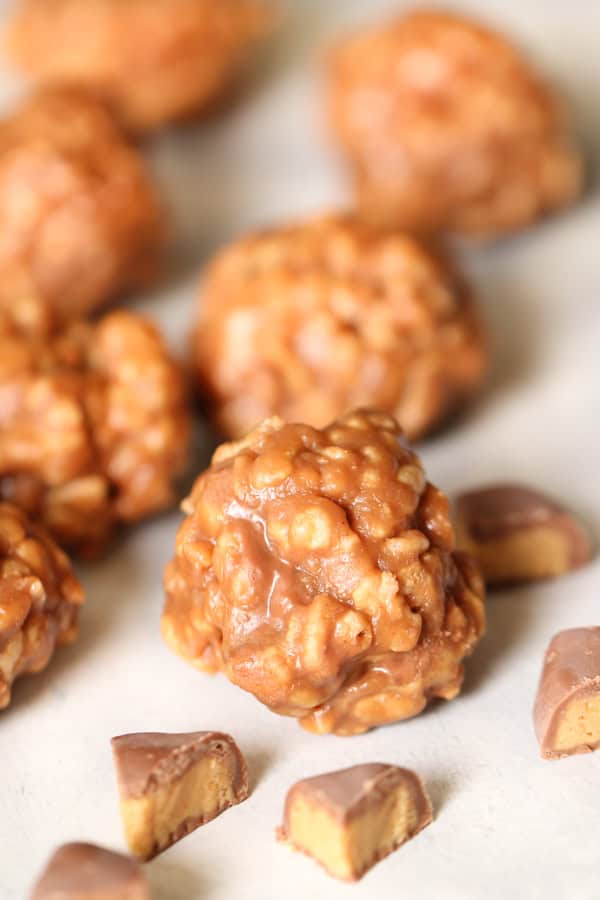 Reese’s Peanut Butter Cup Rice Krispies Treats rolled into a ball surrounded by chopped Reese's Peanut Butter Cups.