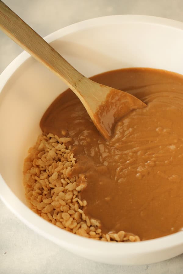 sugar and Corn Syrup sauce poured over rice krispies in a large mixing bowl.
