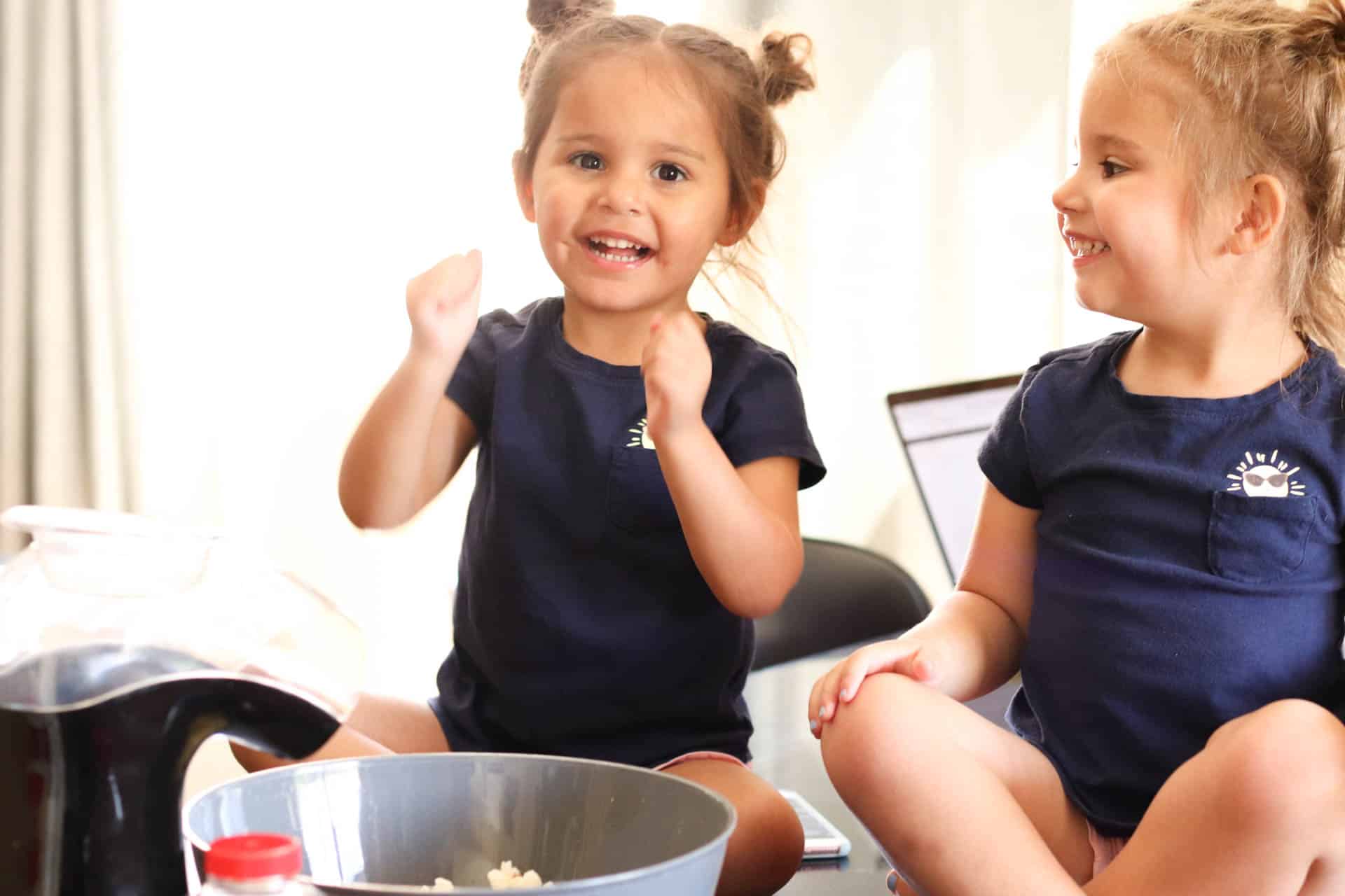 Two little girls with a bowl of popcorn