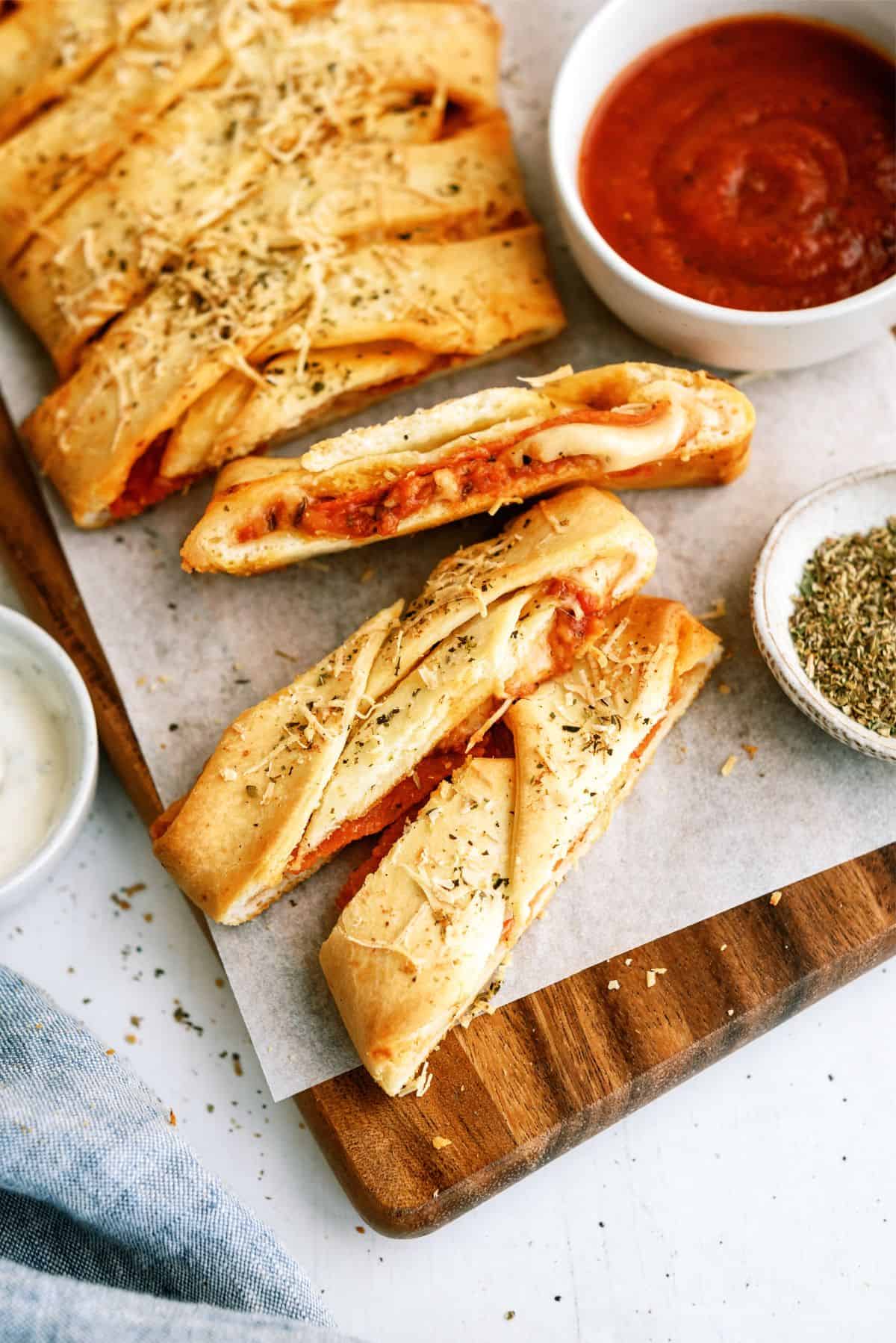 Easy Braided Pizza Loaf on a cutting board sliced