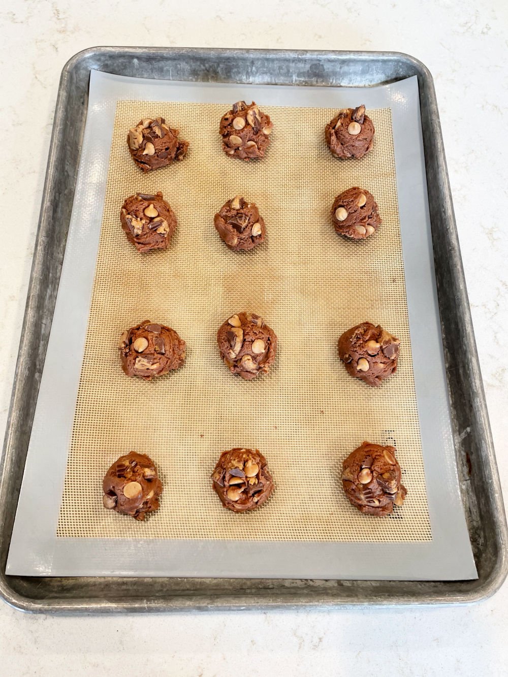 Unbaked Peanut Butter Cup Pudding Cookies on a baking sheet