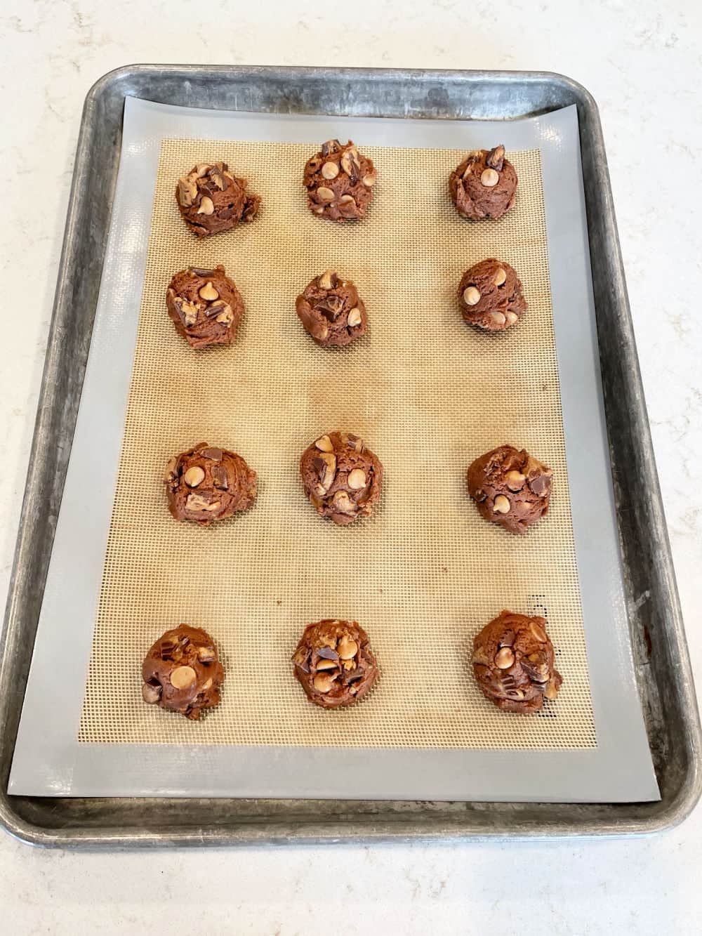 Unbaked Peanut Butter Cup Pudding Cookies on a baking sheet
