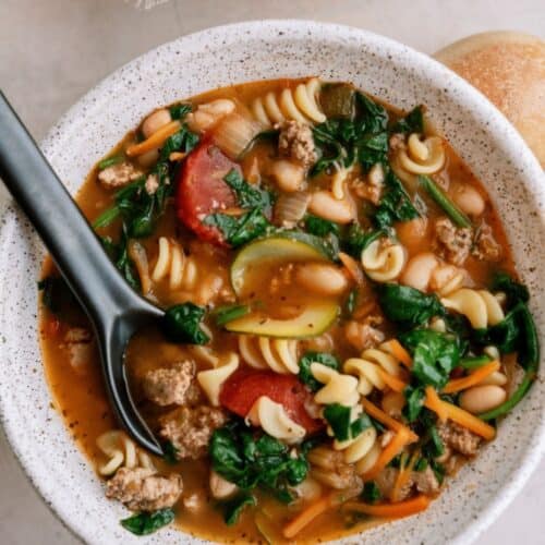 Top view of a bowl of Quick Italian Ground Turkey Soup with a spoon.