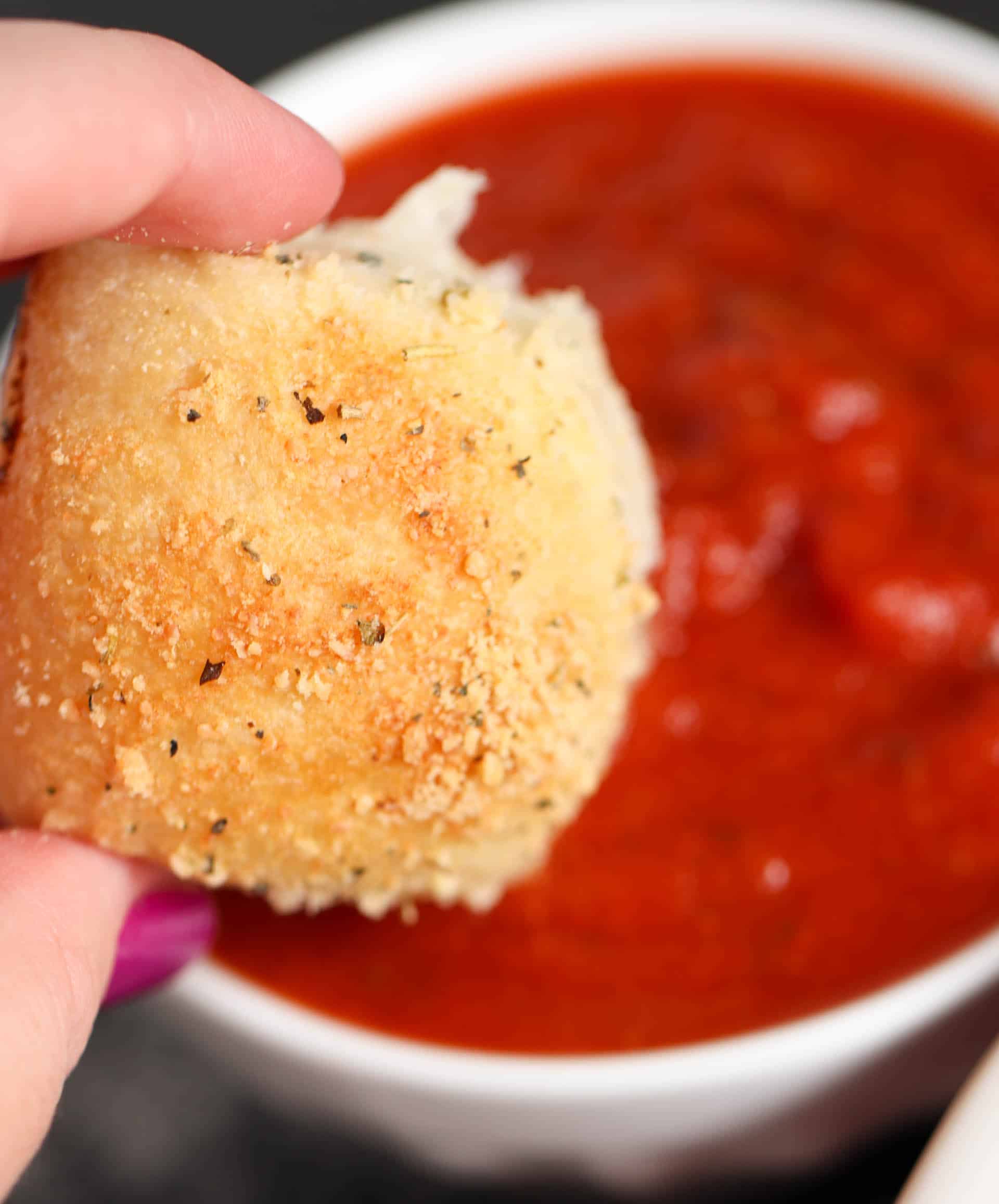 One Stuffed Pizza Roll dipping in marinara