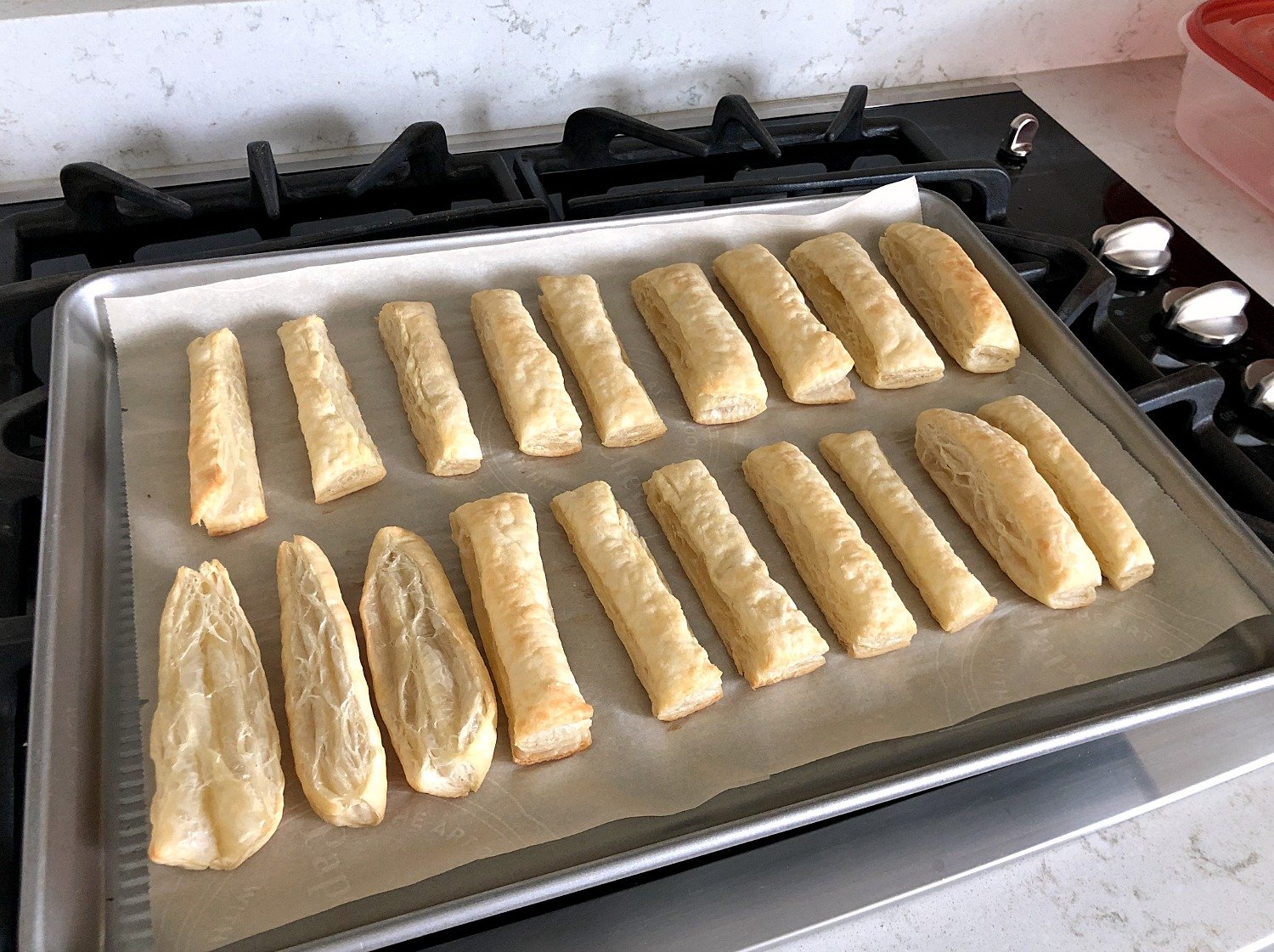 Puff pastry sliced on a baking sheet