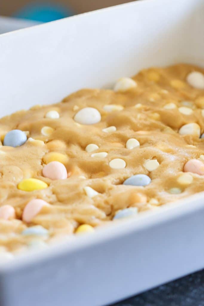 Cadbury Mini Egg Blondie dough pressed into a baking dish.
