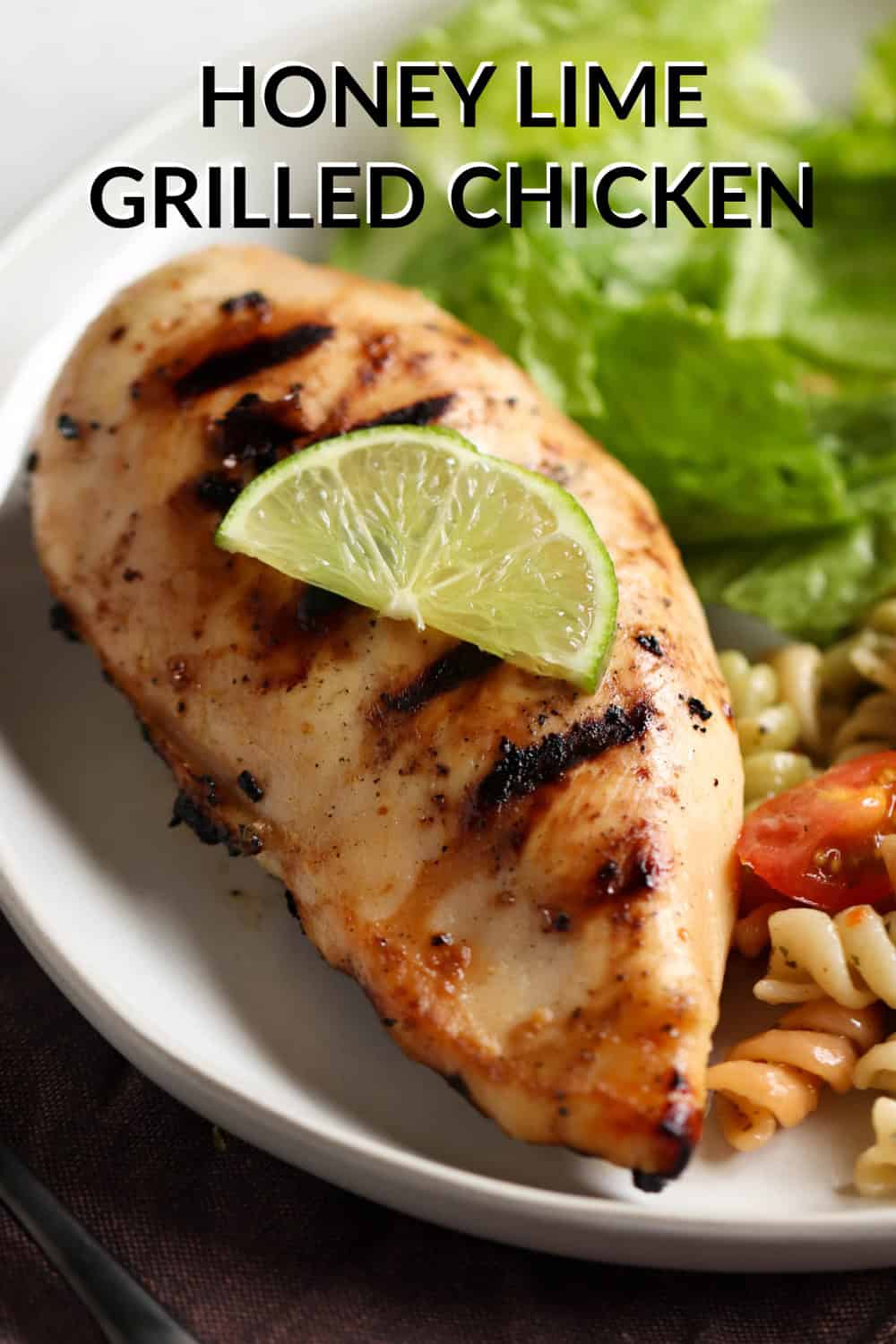 Honey Lime Grilled Chicken on a plate with a side of pasta salad