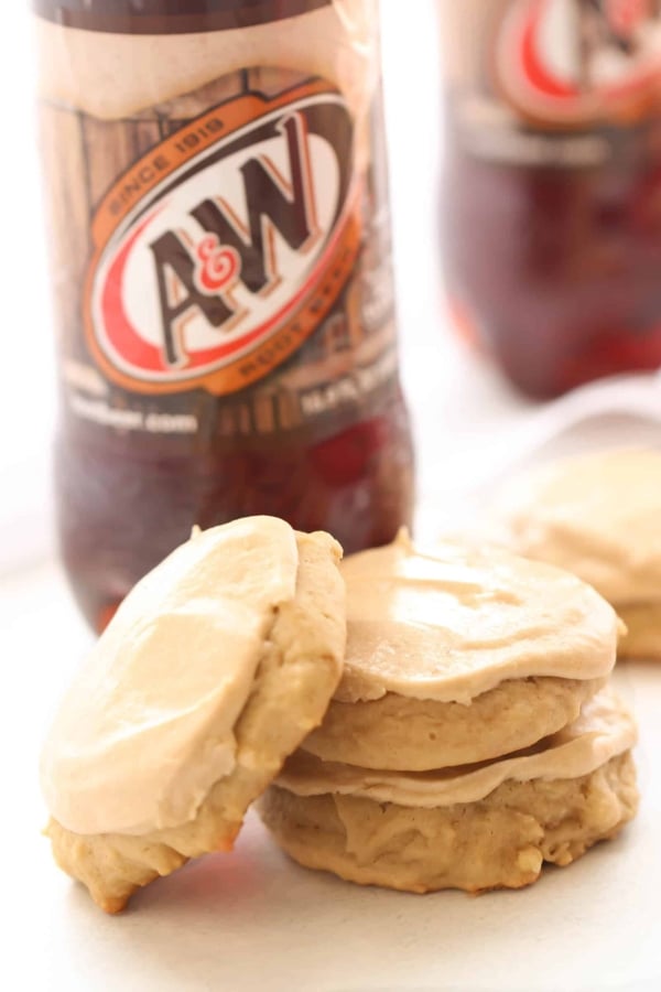 Frosted cookies next to a bottle of A&W Root Beer.
