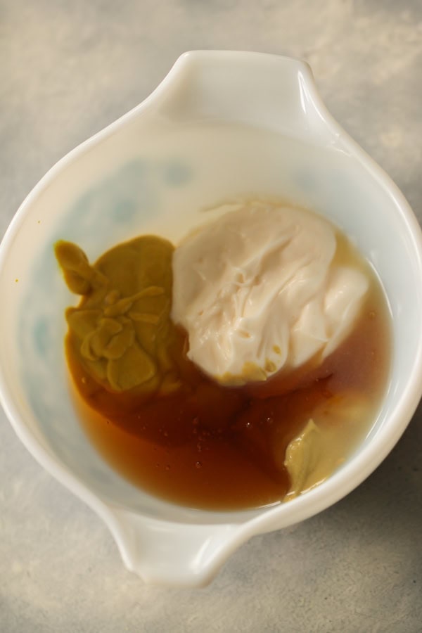 Ingredients for Honey Mustard Dipping Sauce in a white bowl