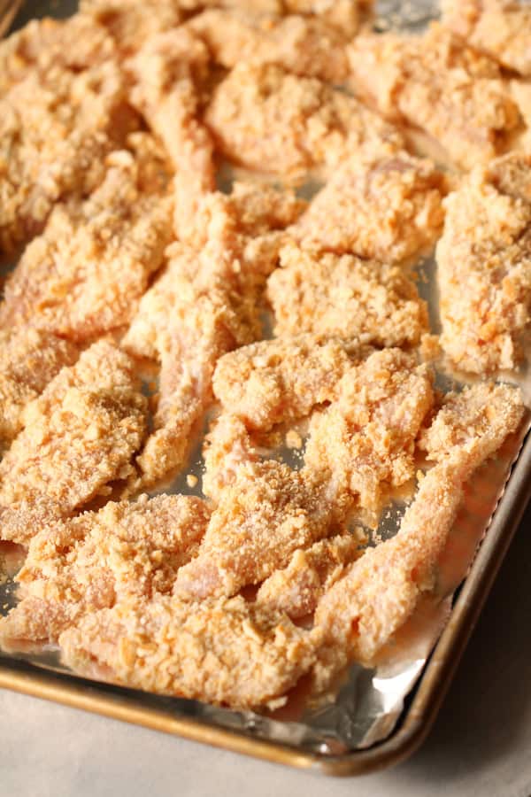 Parmesan Sesame Chicken Strips on baking sheet