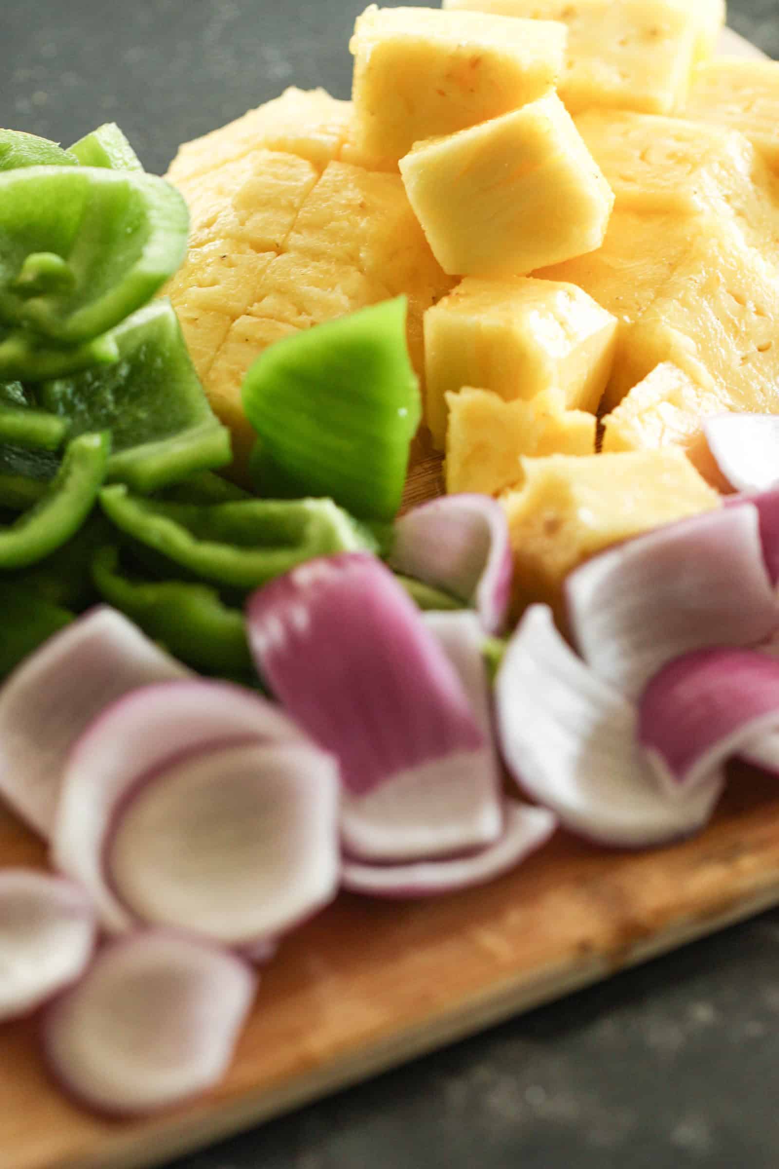 Ingredients for Grilled Island Chicken Kabobs on a wooden cutting board